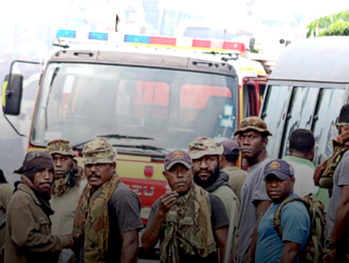 PNG Defence Force soldiers keep watch after running riot in the Port Moresby suburb of Boroko