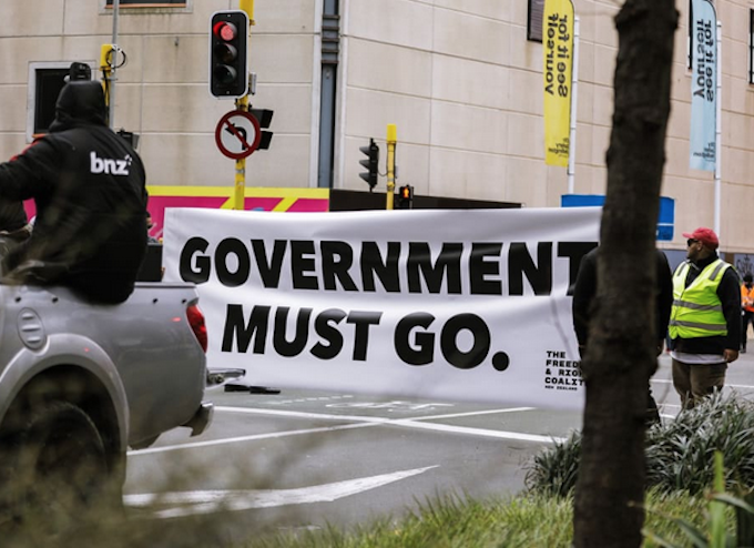 An anti-government protester in Wellington marching towards Parliament