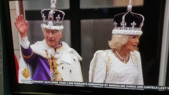 King Charles III and Queen Camilla wave from the balcony at Buckingham Palace