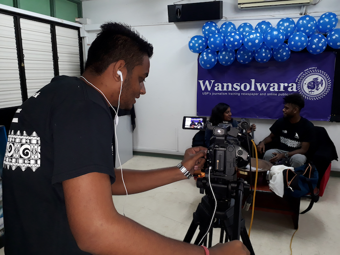 A reporter for Wansolwara tests equipment during USP Open Day