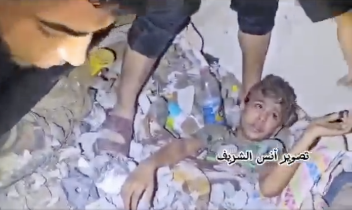 A Palestinian child being rescued alive from the rubble of his family home in Gaza