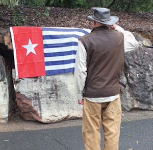 Author Jim Aubrey salutes the Morning Star flag of West Papuan independence