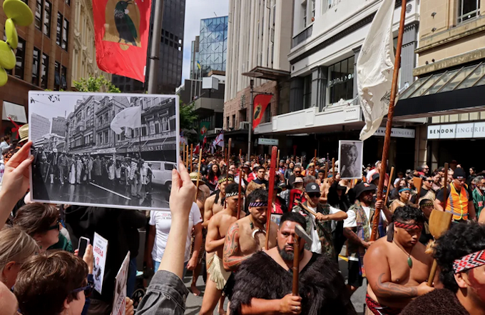 John Miller's photograph of the 1975 Land March held up in the same location at the 2024 Hīkoi