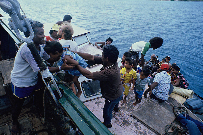 Rainbow Warrior crew help Rongelap islanders load up the ship