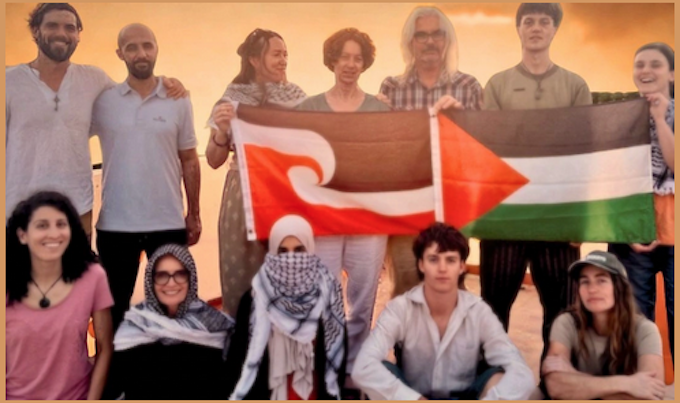 New Zealand and other activists with Tino Rangatiratanga and Palestine flags