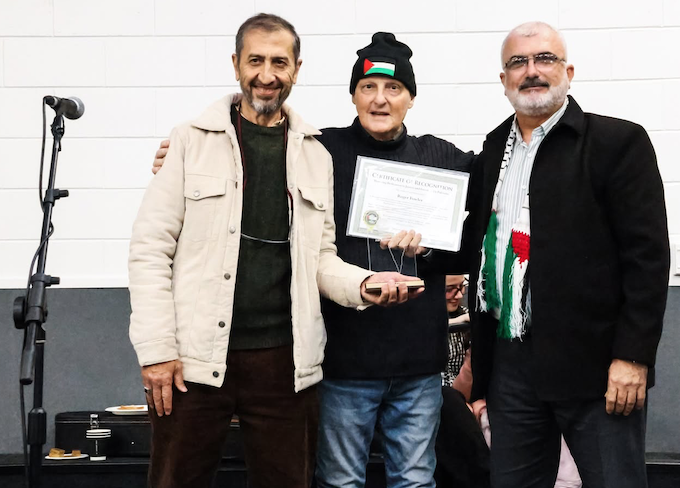 The Palestinian community presenting Roger Fowler an award at the launch of his album in September 2025