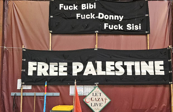 “Free Palestine” banners at the exhibition