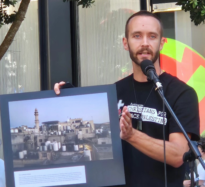 Journalist Cole Martin speaking at the UN Solidarity Day rally in Auckland recently