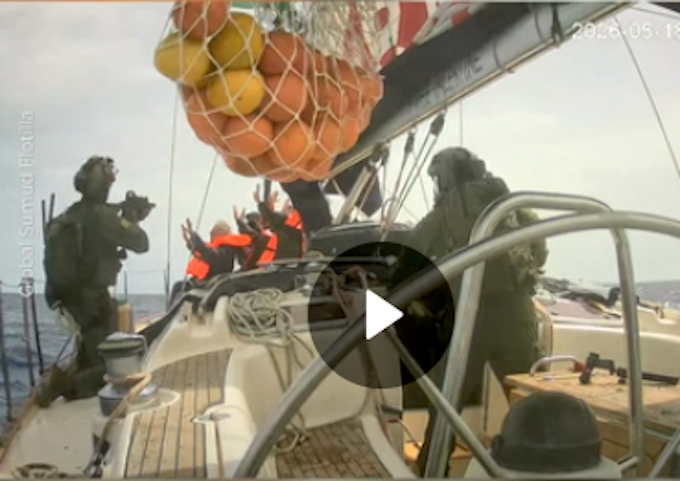 Israeli soldiers board a Gaza-bound humanitarian aid flotilla vessel and hold the crew at gunpoint